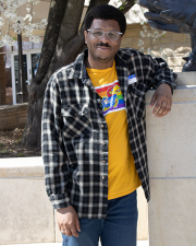 Cornelius Baker leaning against a limestone pillar